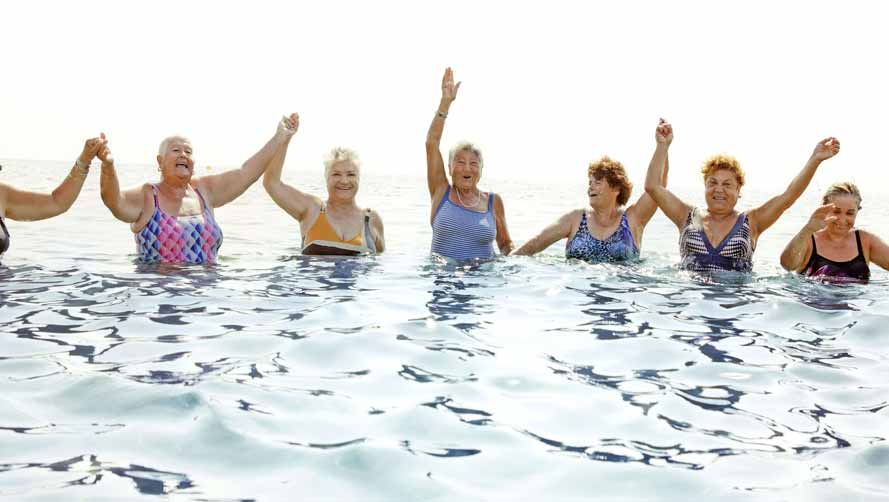 A large group of seniors having fun in the water