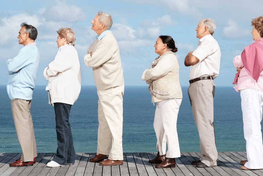 Group of 6 seniors waiting in line with arms crossed