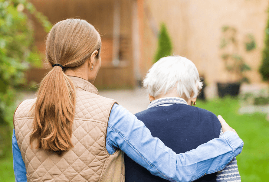 Younger woman with her arm around older woman