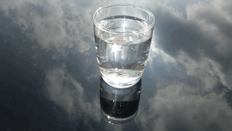 A glass of water on a reflective surface