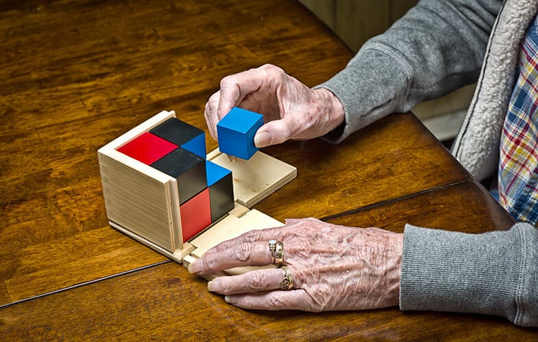 Senior-Woman-Dementia-Patient-Works-on-a-Puzzle