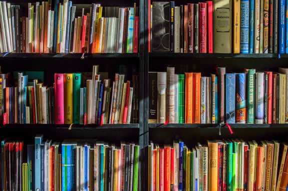 A bookshelf filled with brightly coloured books