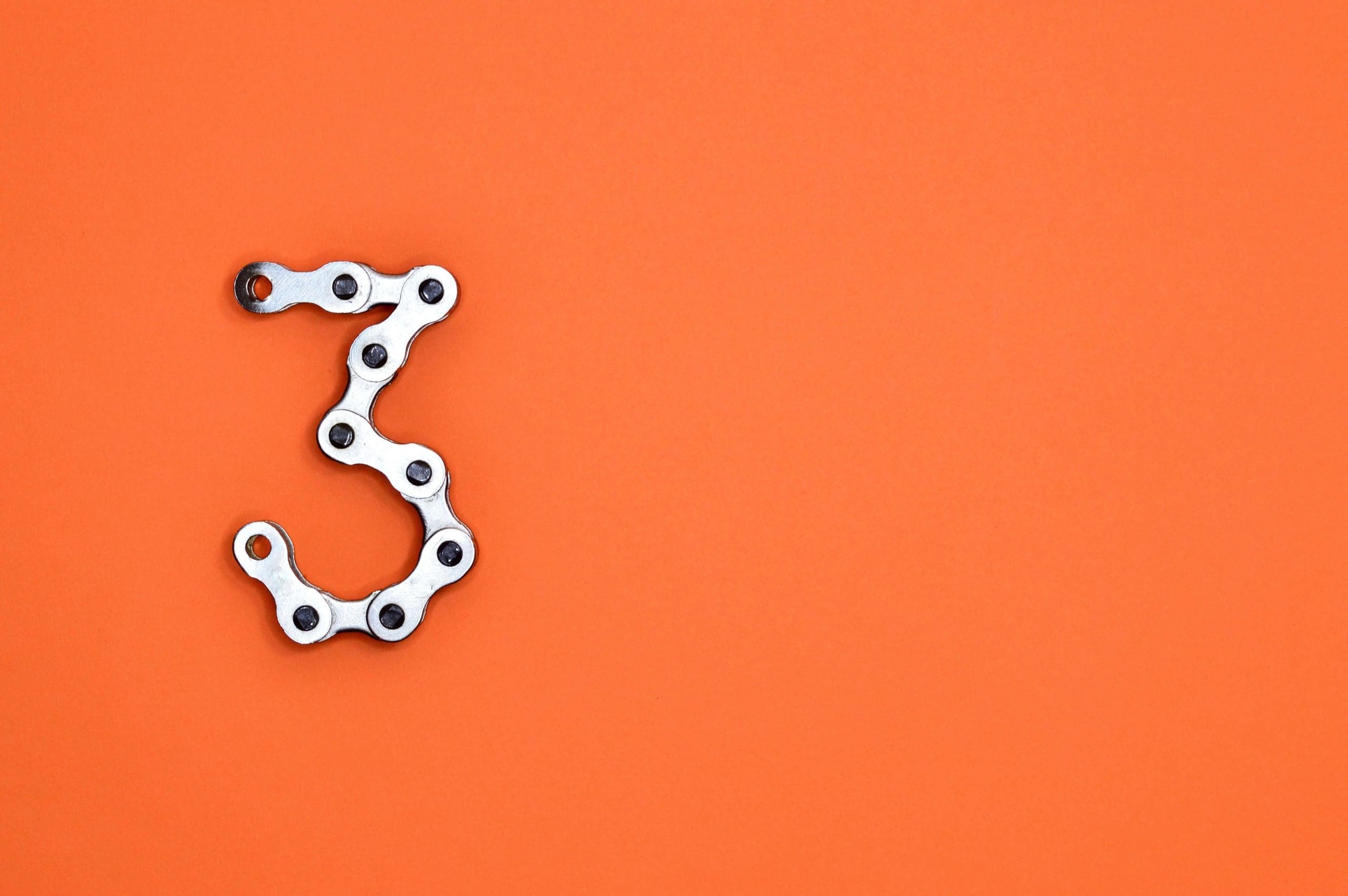 A white number 3 against an orange background