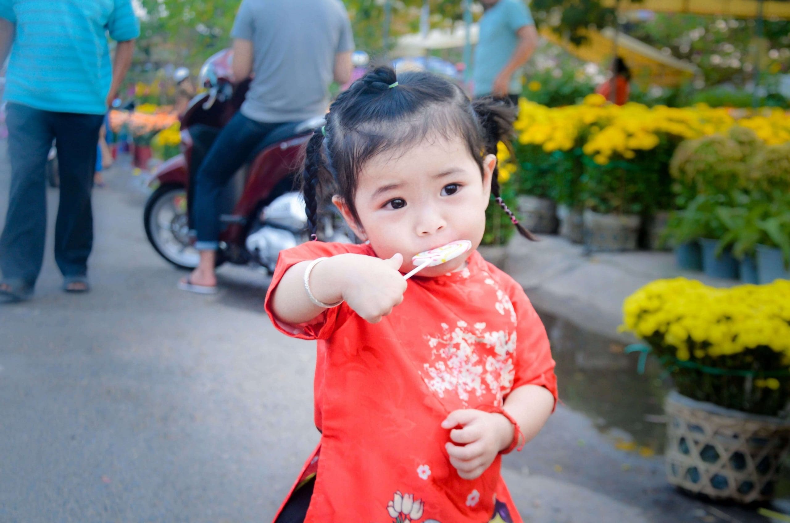 Young toddler eating a lollipop