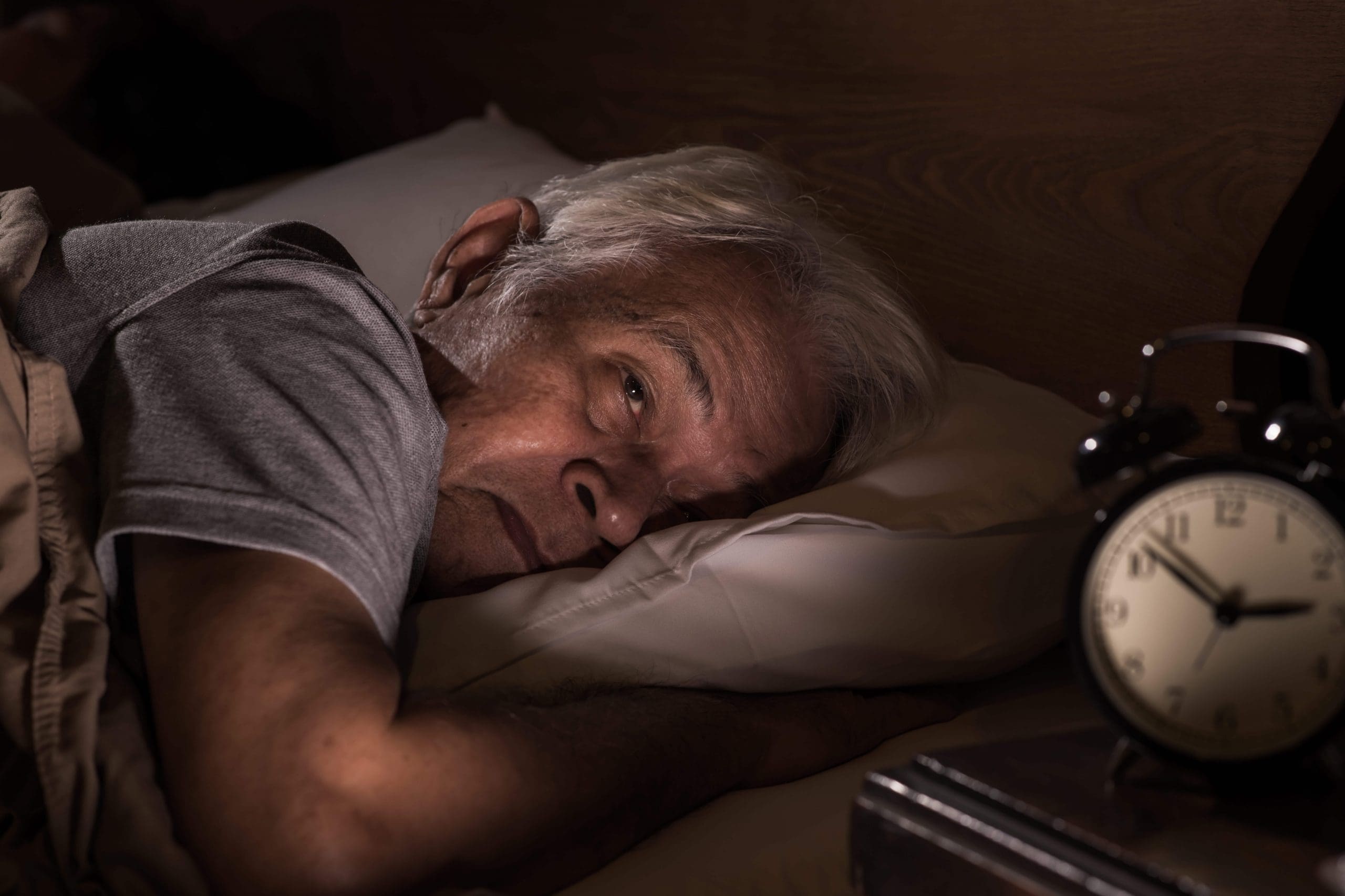 Senior Asian man trying to sleep