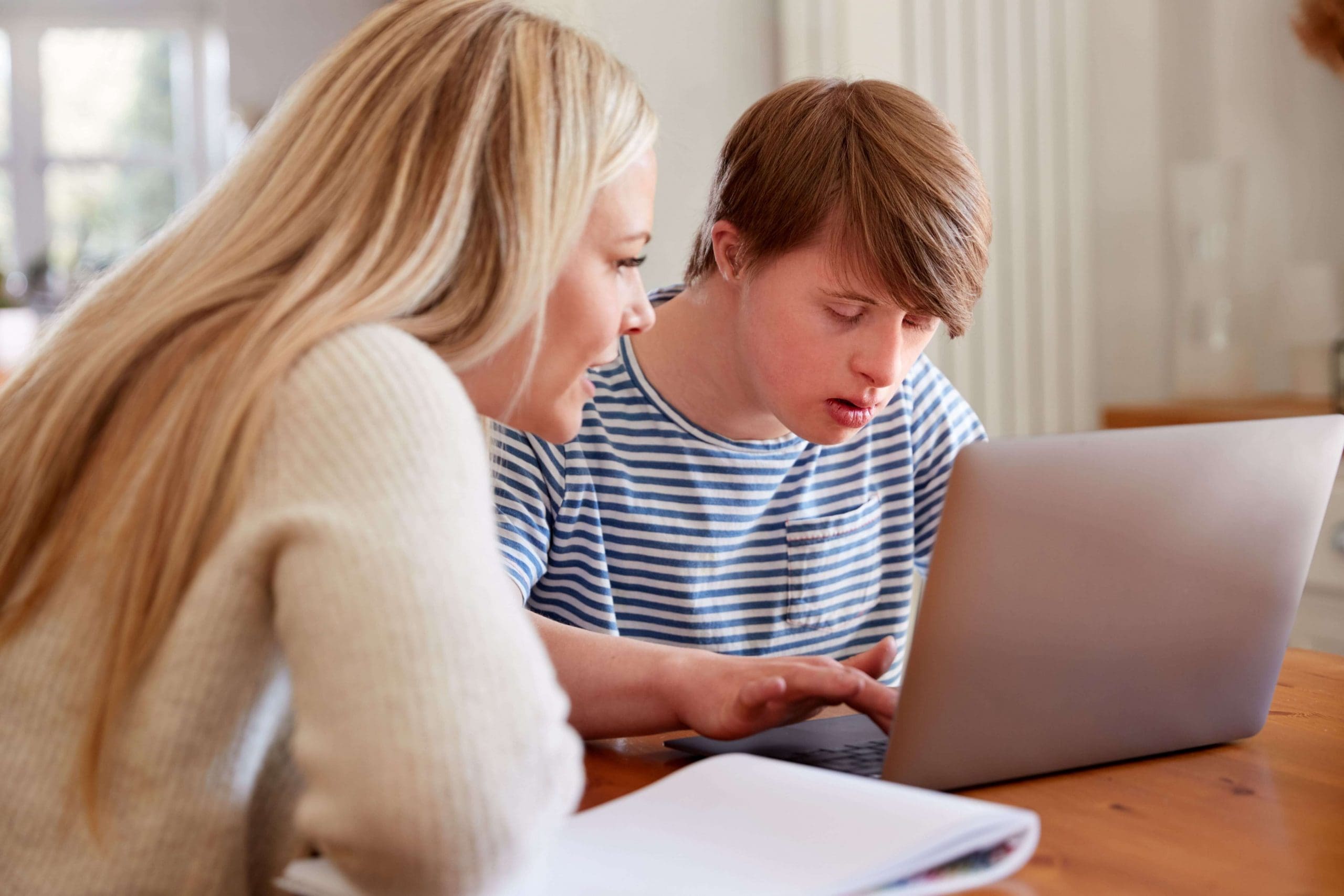Young man with Down Syndrome and his female support worker