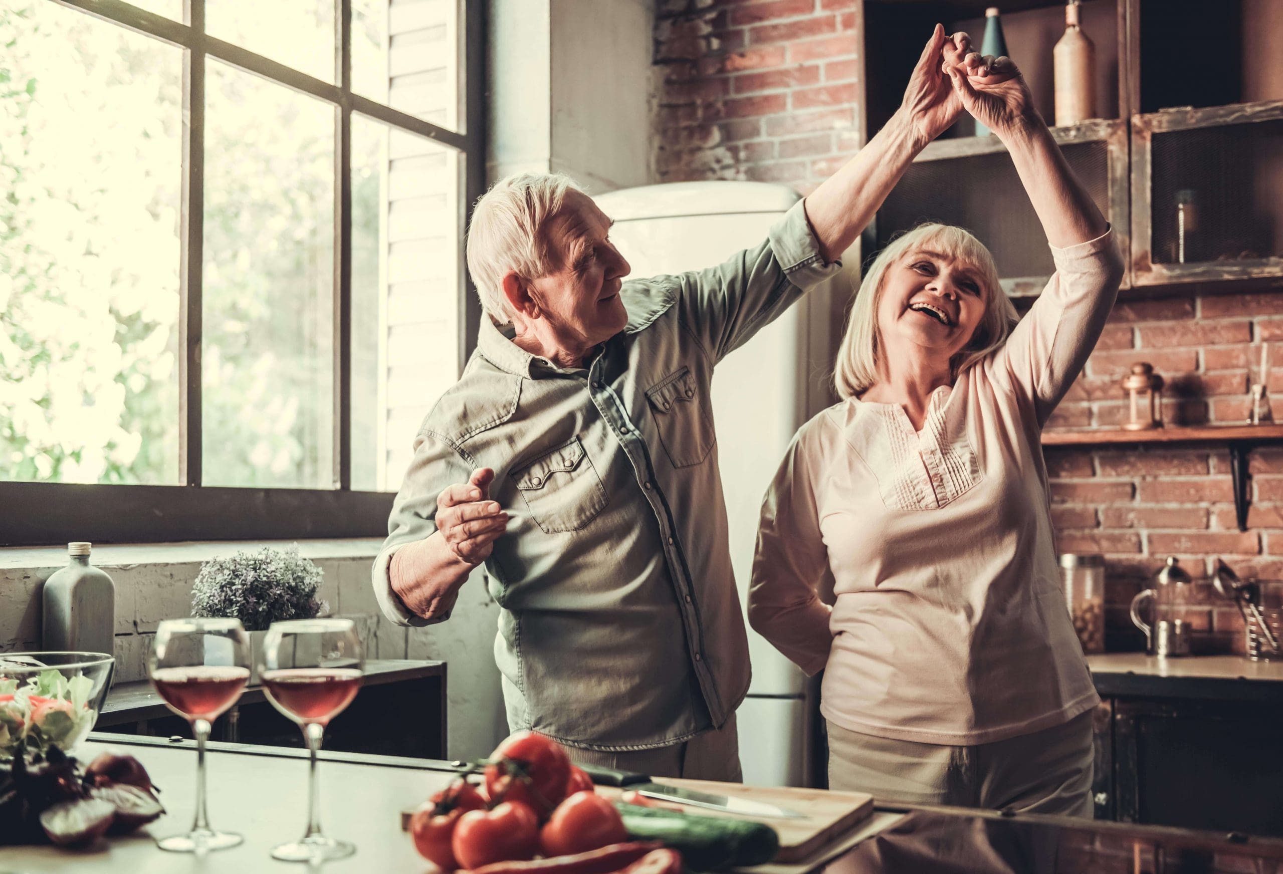 Senior couple dancing in their kitchen