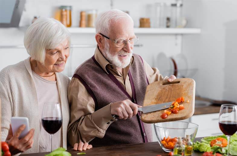 Senior couple preparing a meal together in their kitchen